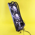 A sleek triple fan liquid cooler on a vibrant yellow background, showcasing modern cooling technology.
