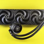 Triple fan CPU cooler with colorful background, efficient for gaming PCs.