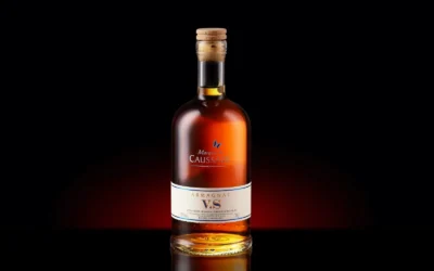 A bottle of Armagnac VS with a cork, elegantly displayed against a dark background.