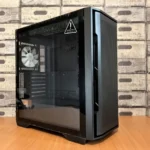 A modern black computer case with tempered glass panel on a wooden desk, ideal for tech enthusiasts.