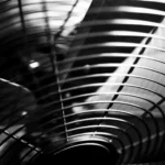 Black and white macro shot of industrial fan blades with abstract patterns.